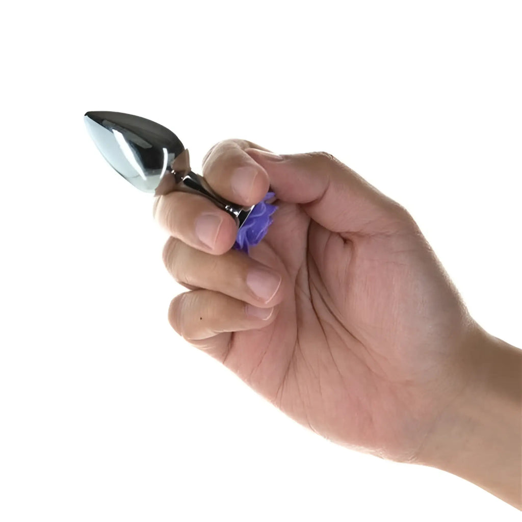 A sleek metallic spoon with polished silver finish and vibrant purple handle featured in LUX Active Purple Rose 3in metal butt plug