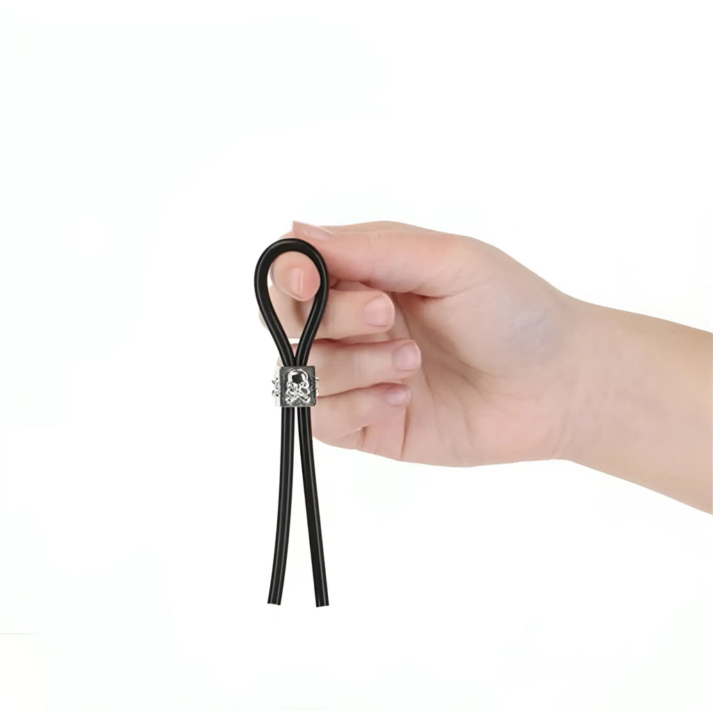 Black elastic cord adjustable cock tie with silver-toned skull charm clasp for luxury active tether use