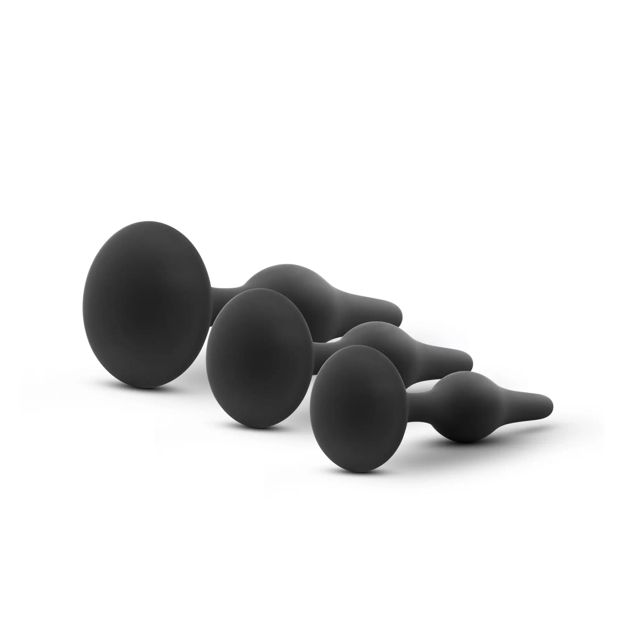 Set of four black silicone anal plugs with smooth rounded heads and tapered stems from Luxe Luxe beginner plug kit