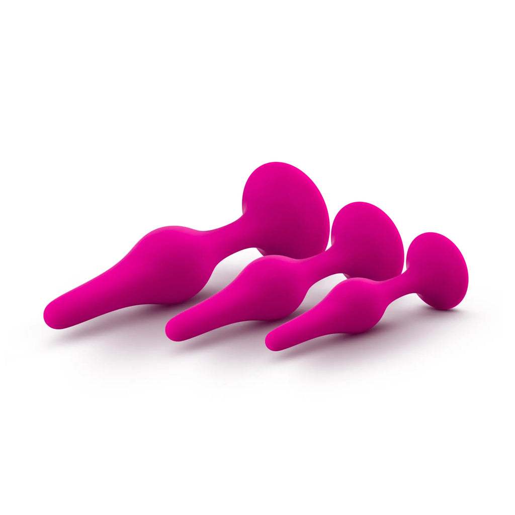 Set of three vibrant fuchsia silicone anal plugs with smooth rounded designs from luxe beginner plug kit pink
