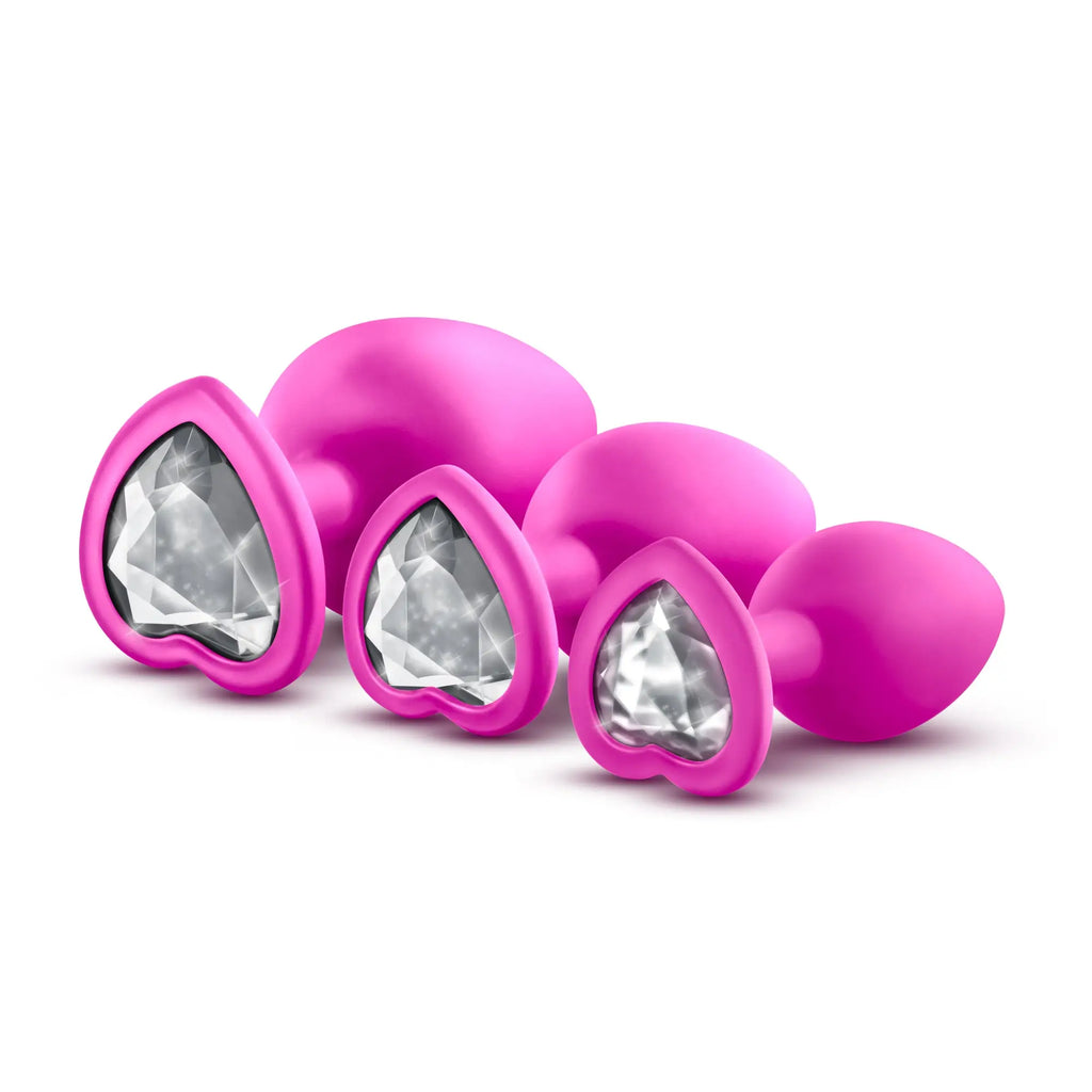 Set of three vibrant pink heart-shaped anal plugs with clear faceted white gems in luxe luxe bling plugs training kit