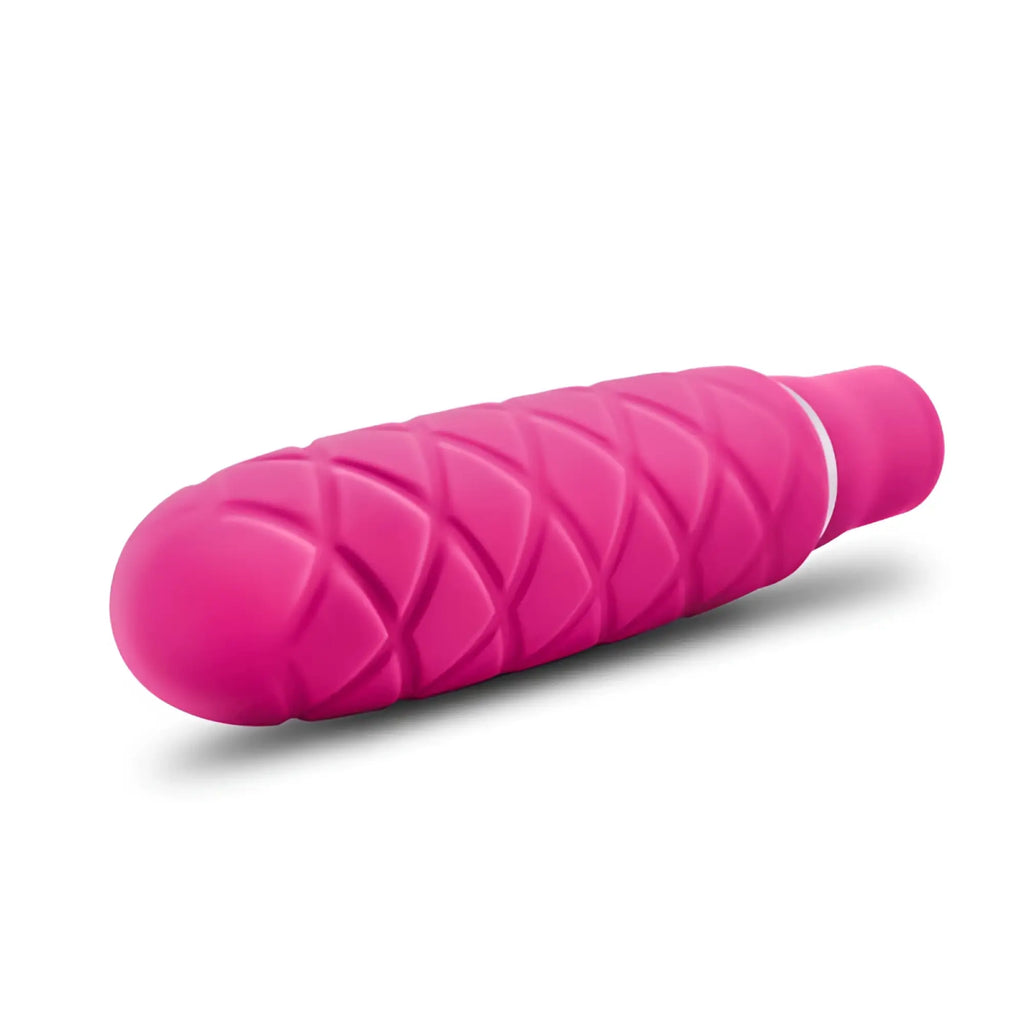 A vibrant pink luxe luxe cozi mini fuchia silicone vibratory toy with diamond-patterned grip and smooth rounded ends