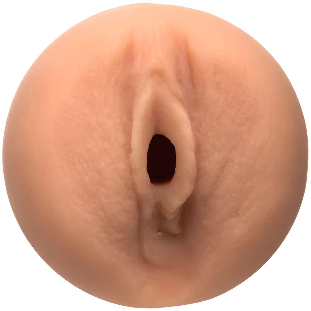 A peach-colored realistic silicone anal plug with central opening and textured surface from main squeeze remy lacroix pussy
