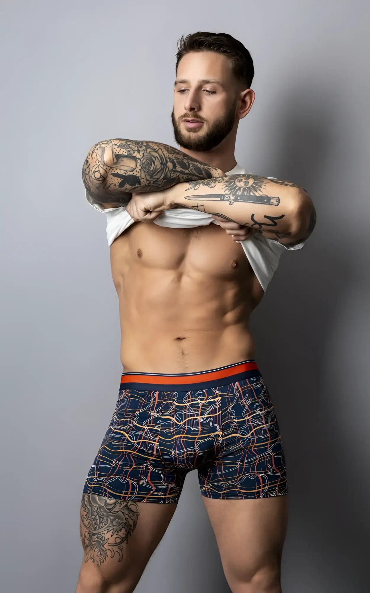 Navy blue male power soo cumfy boxer briefs with vibrant orange pink and white geometric pattern and orange waistband