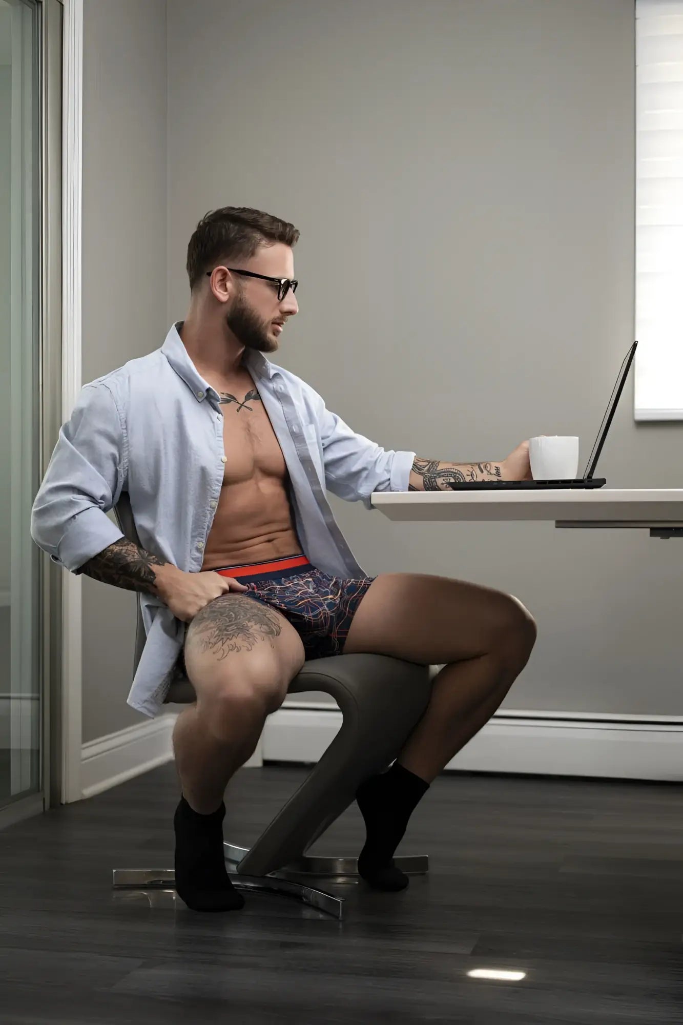 Man wearing male power soo cumfy navy patterned boxer briefs with red waistband showing front side