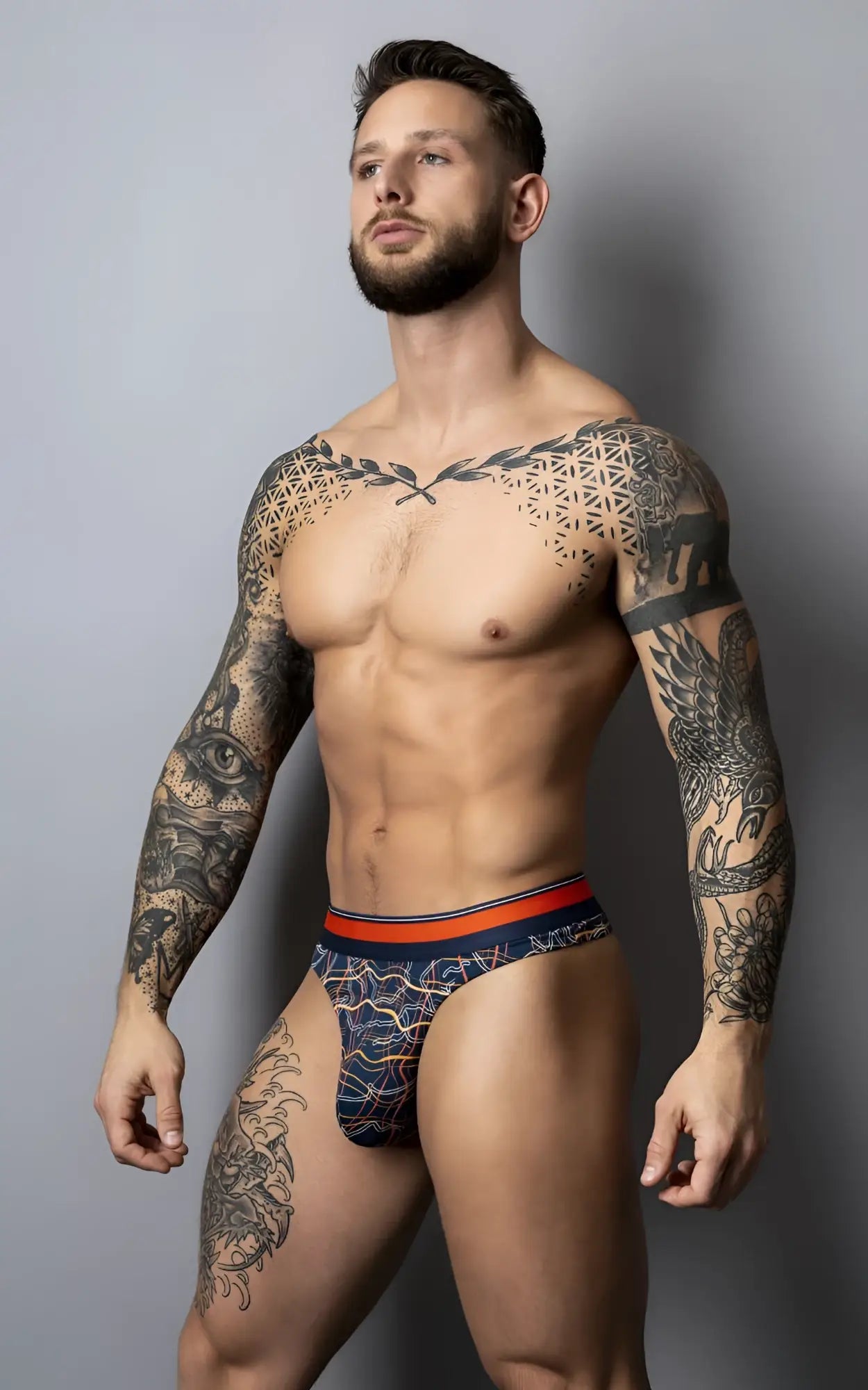 Male power 412-299 soo cumfy thong navy briefs with orange waistband featuring a patterned navy fabric and comfortable fit