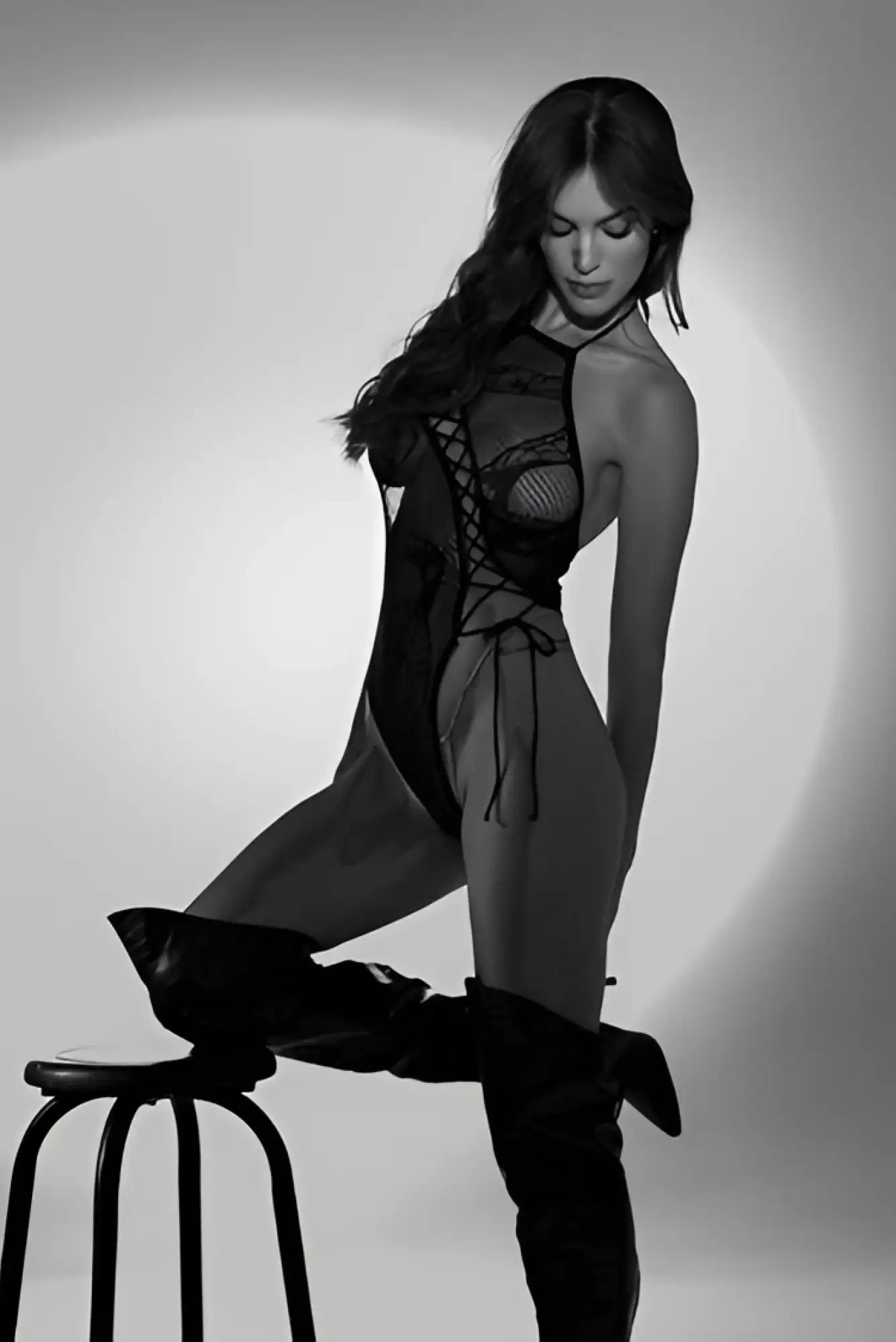 Black lace bodysuit with mesh panels and crisscross lacing detail by Mapale in black color, front view