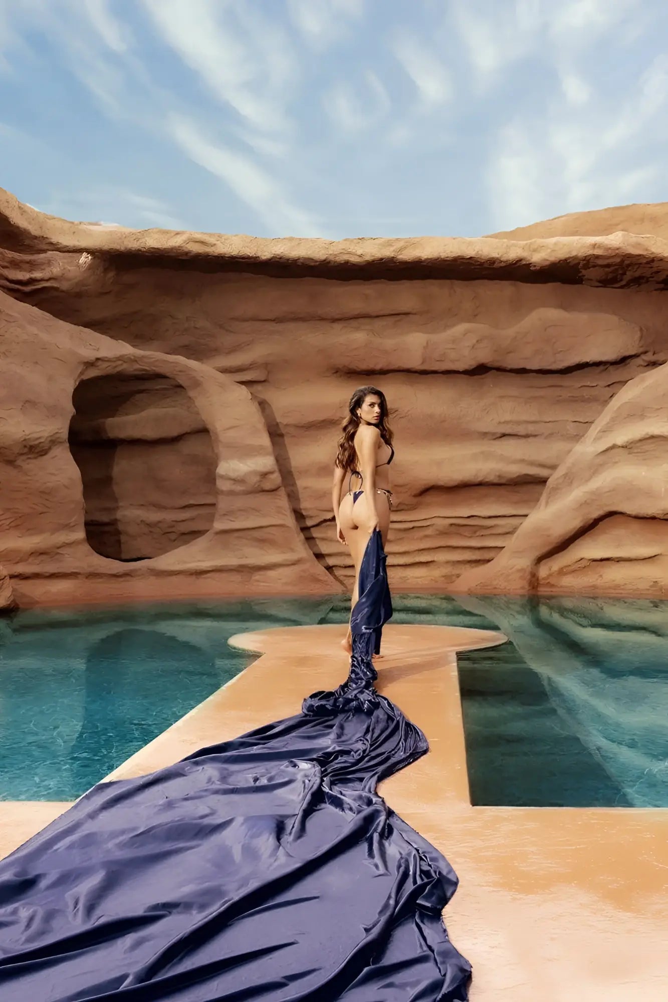 A flowing deep navy blue satin fabric drapes elegantly from a woman wearing the mapale 67158 two piece swimsuit