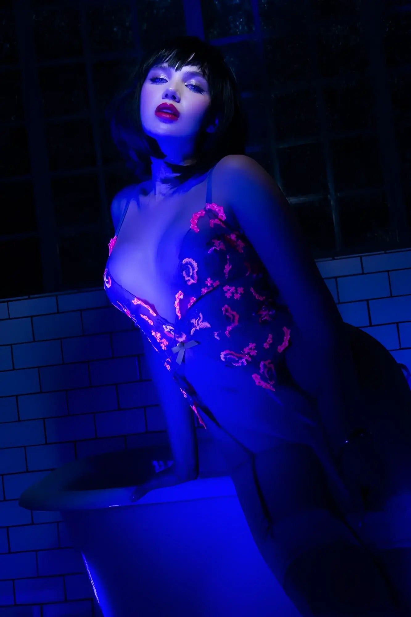 Mapale 80011 bodysuit in hyacinth reverie color featuring dark sheer fabric with vibrant pink embroidered floral patterns