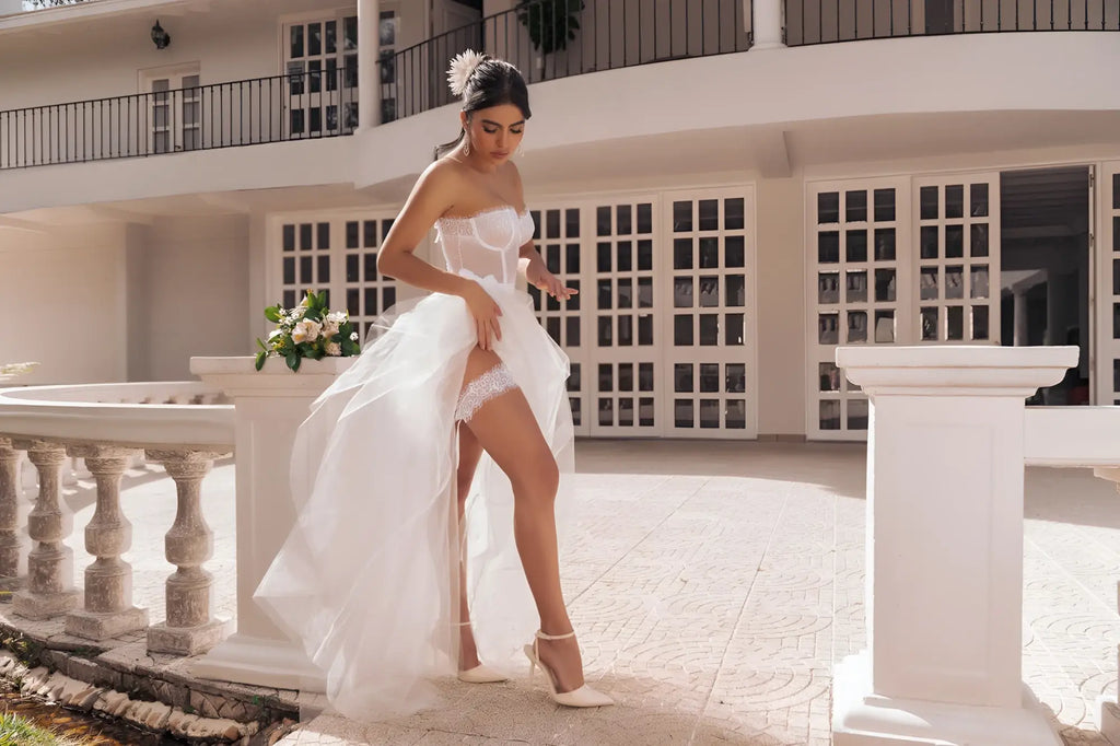 A flowing white bridal gown from mapale 8933 four piece set with high slit and delicate lace trim