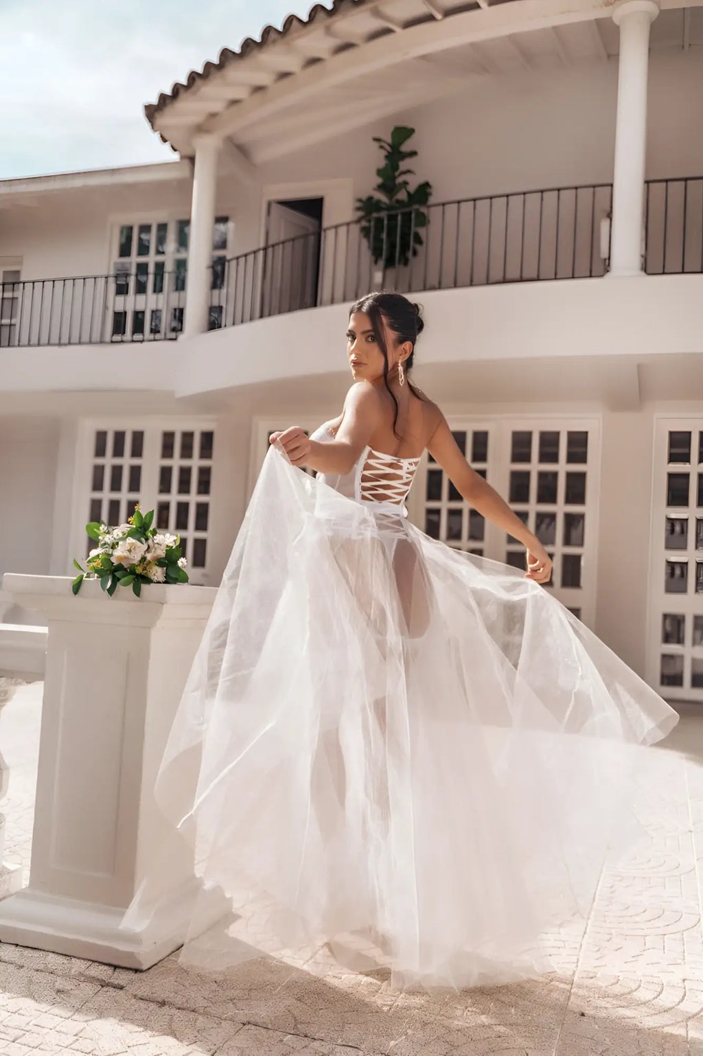 Back view of mapale 8933 four piece set flowing white wedding gown with lace up corset back and sheer tulle skirt