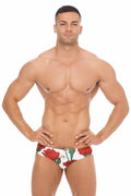 White swim trunks with vibrant red roses and green stems from marcuse amour bikini swimwear collection