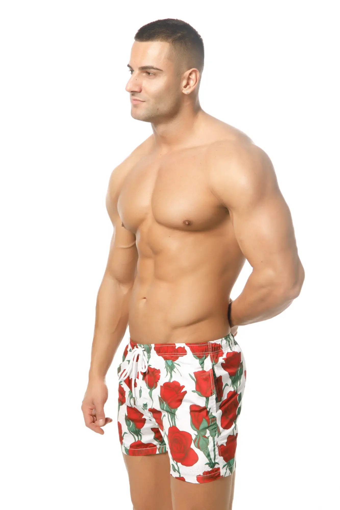 White swim trunks marcuse amour shorts with bold red rose pattern and green stems for stylish beachwear
