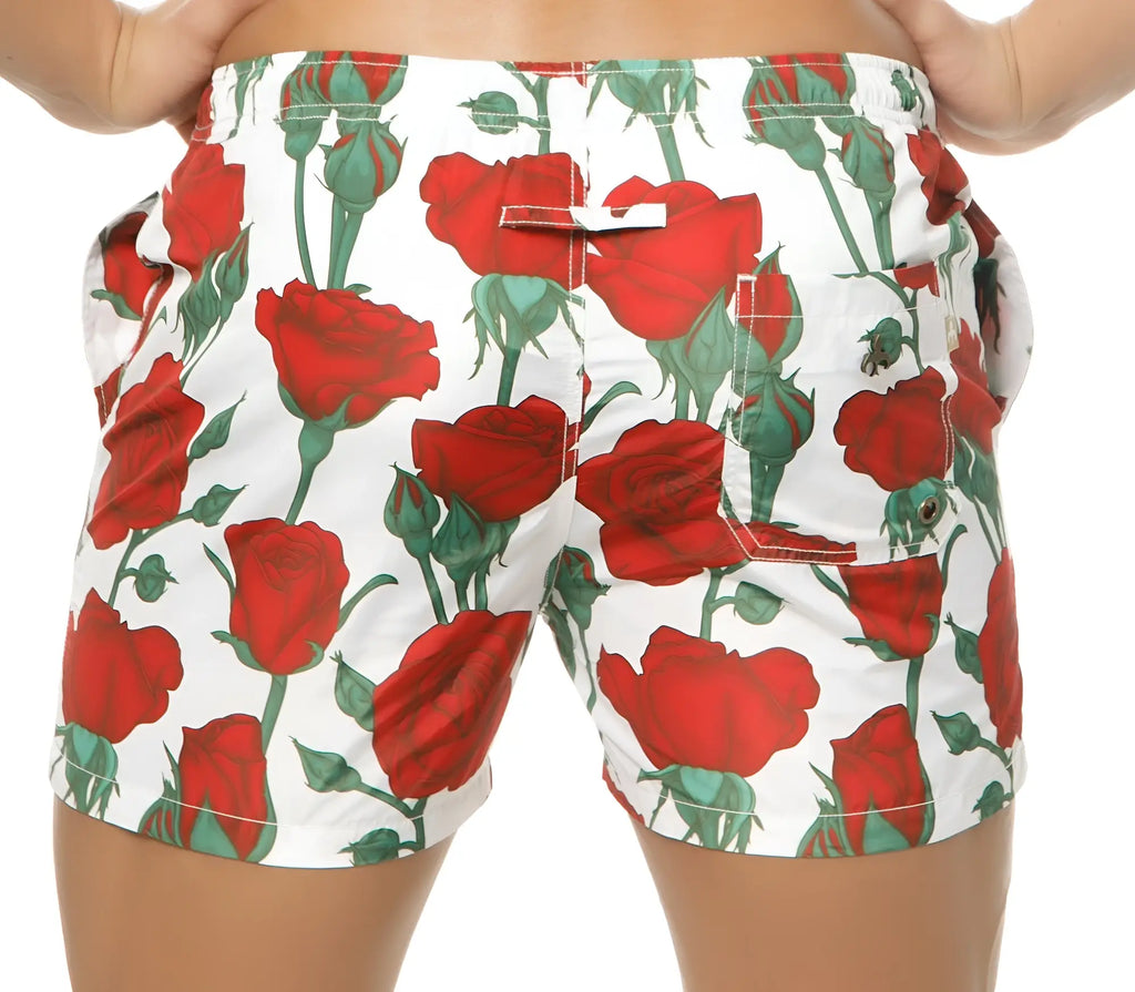 Marcuse Amour shorts white swim trunks with vibrant red rose and green stem pattern designed for beachwear