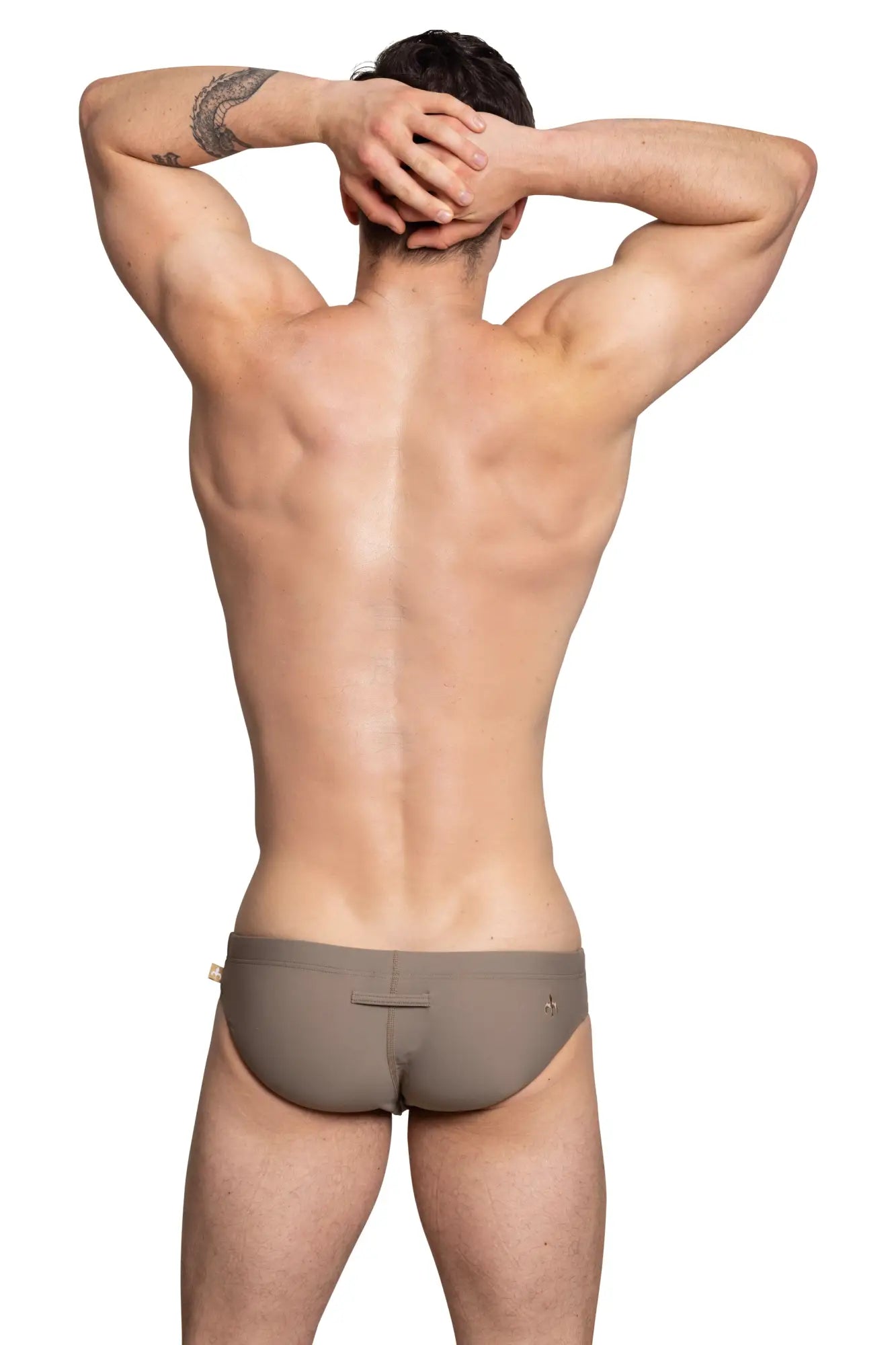 Beige Marcuse Arrest Me bikini swimwear briefs with subtle back seam and small logo detail shown from the back side