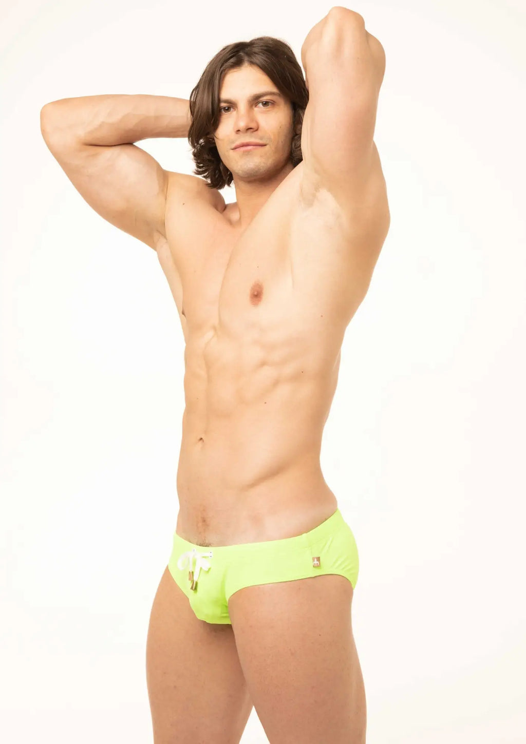 Bright neon green Marcuse Arrest Me bikini swim trunks with a subtle logo on the left hip for swimwear use