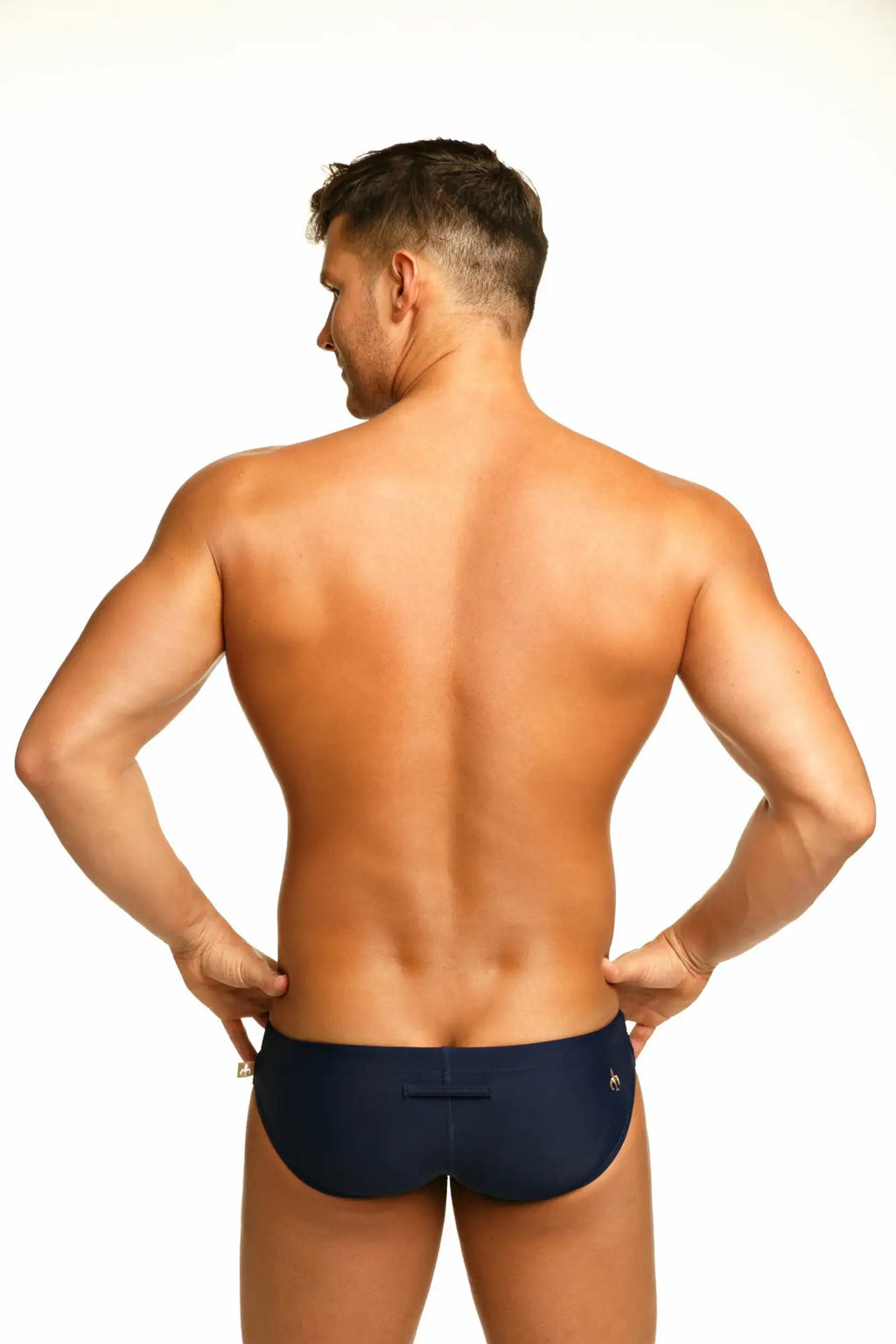 Navy blue Marcuse Arrest Me bikini swimwear briefs with a small gold logo on the back waistband shown from behind