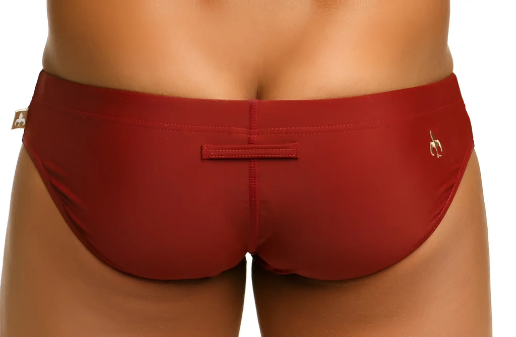 Red marcuse arrest me bikini swimwear men’s swim trunks with subtle side logo and small back rectangular patch shown from back