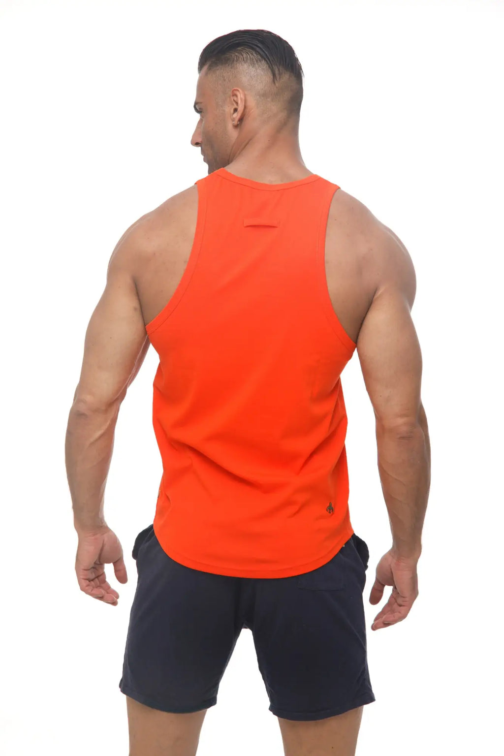 Bright orange marcuse avalon sleeveless athletic tank top with small black logo on lower right side
