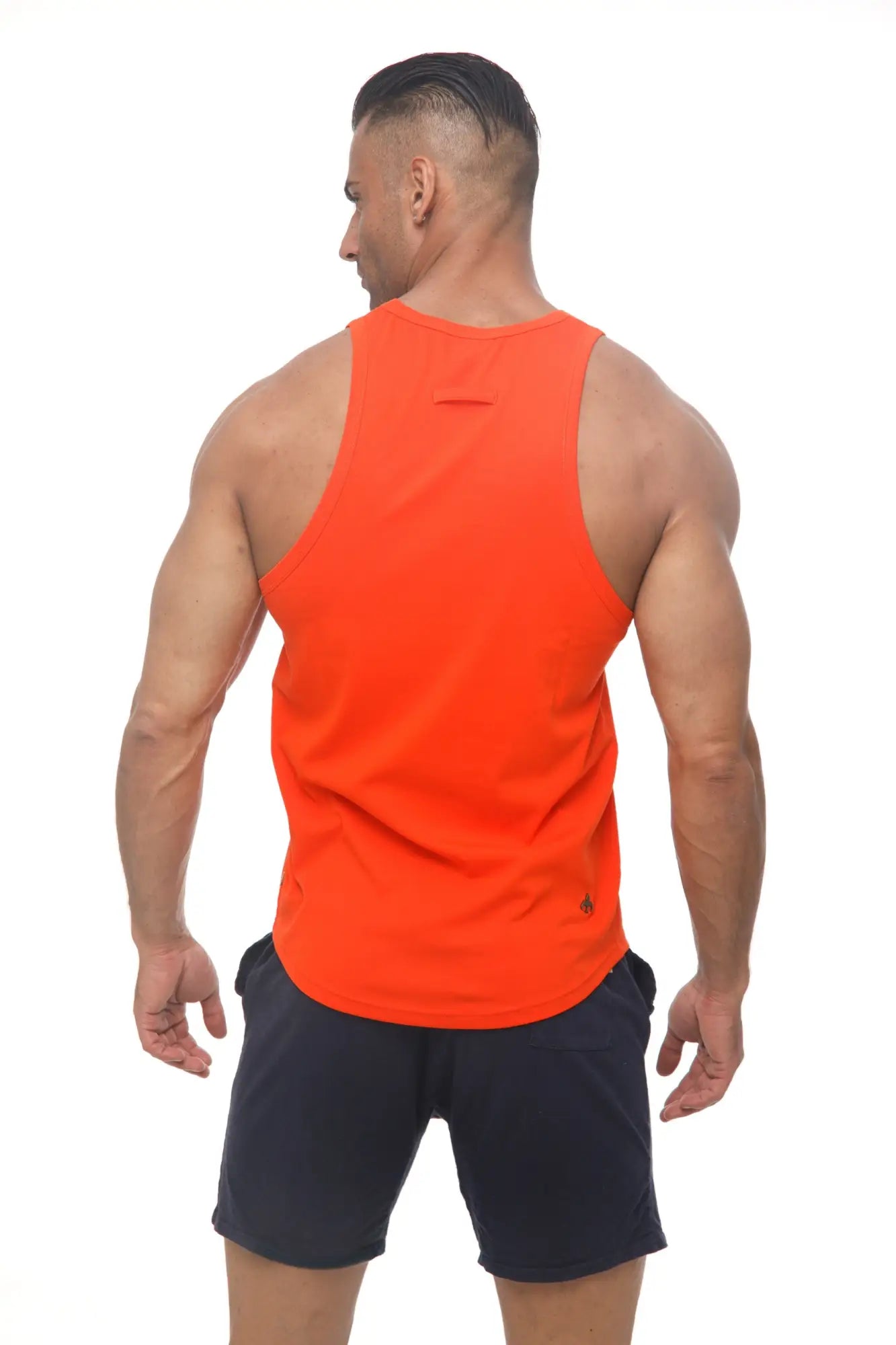 Bright orange marcuse avalon sleeveless athletic tank top with small black logo on lower right side