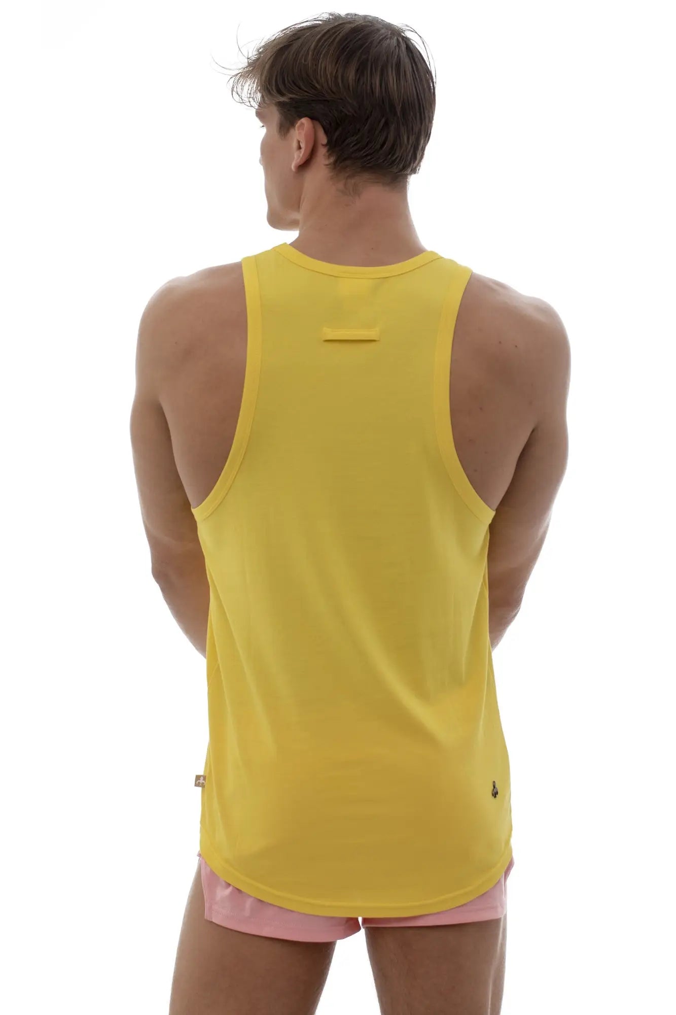Bright yellow marcuse avalon tank top back view with sleeveless design and small brand logos at the neckline seam