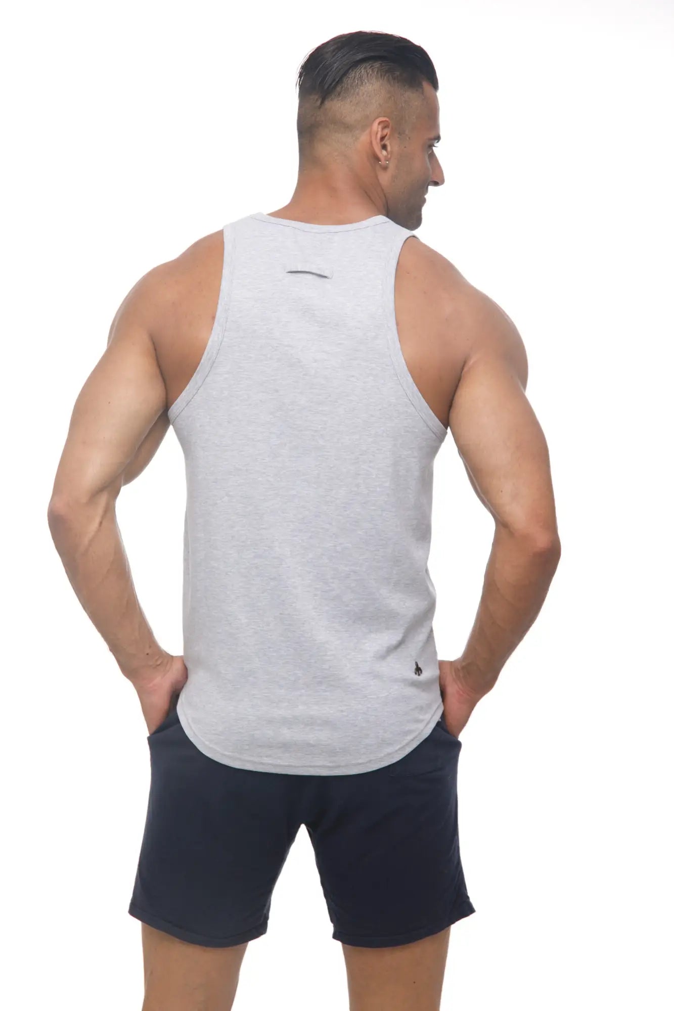 Back view of a heather gray marcuse avalon sleeveless athletic tank top with black logo and small emblem on hem