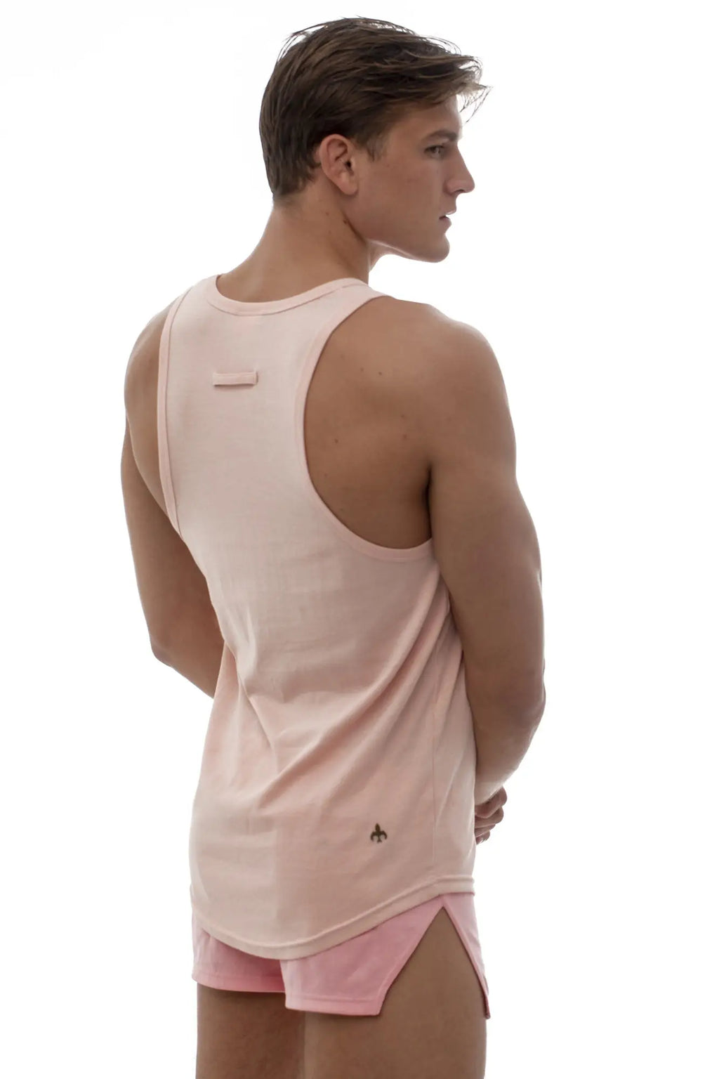 Marcuse Avalon tank top back view soft pink sleeveless athletic ribbed texture with small logo on lower back