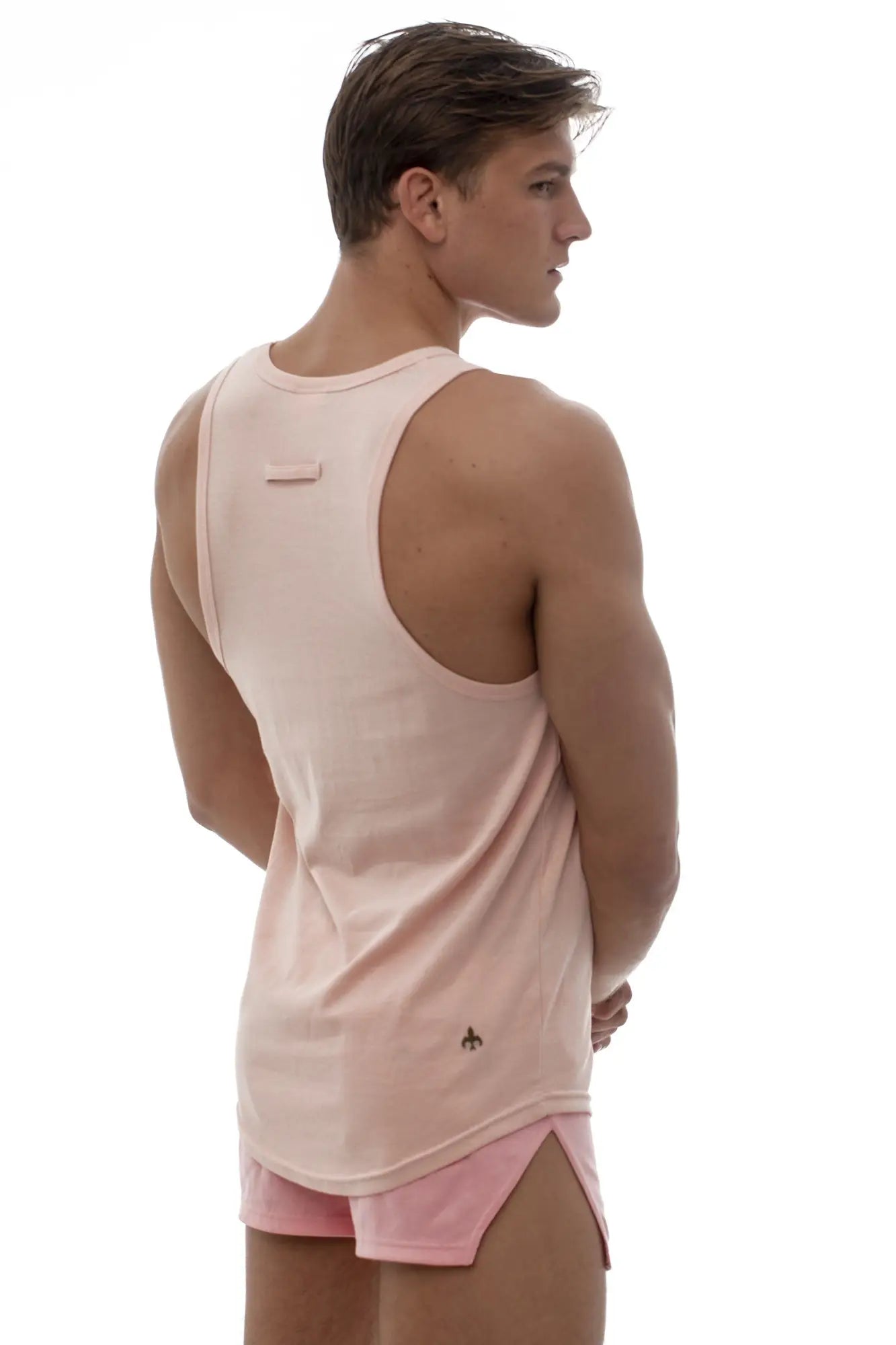 Marcuse Avalon tank top back view soft pink sleeveless athletic ribbed texture with small logo on lower back