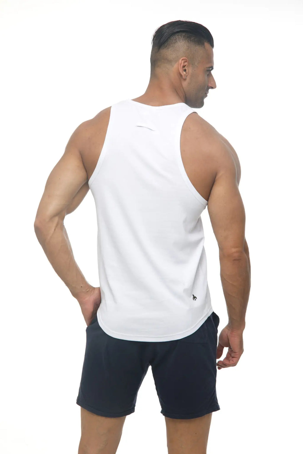 White sleeveless Marcuse Avalon tank top showing the back with a subtle logo, made from breathable athletic fabric