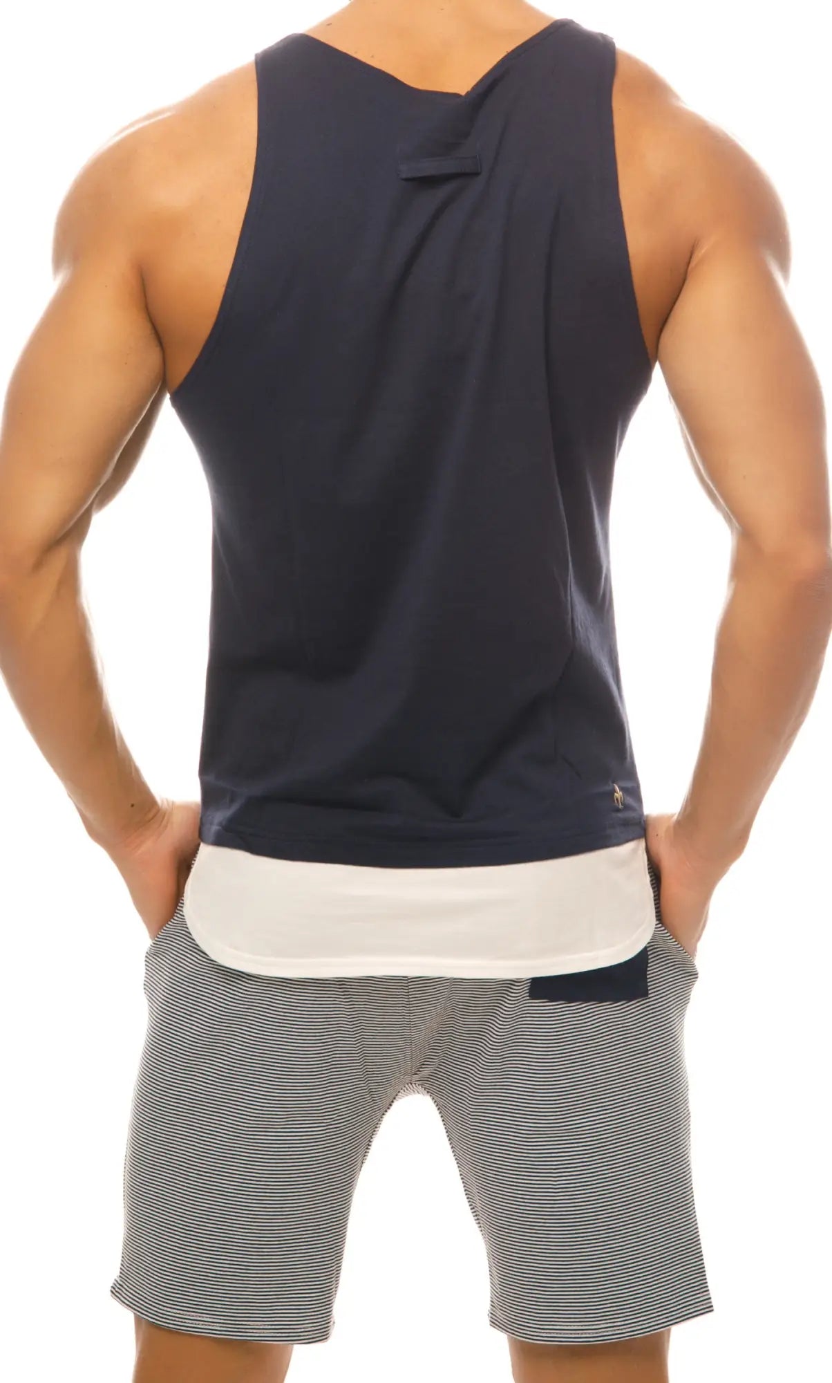 Back view of navy blue Marcuse Babe tank top with white inner lining and small logo on lower back
