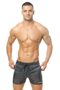 Black drawstring marcuse babylon swim trunks with subtle textured pattern and marcos logo on lower right leg
