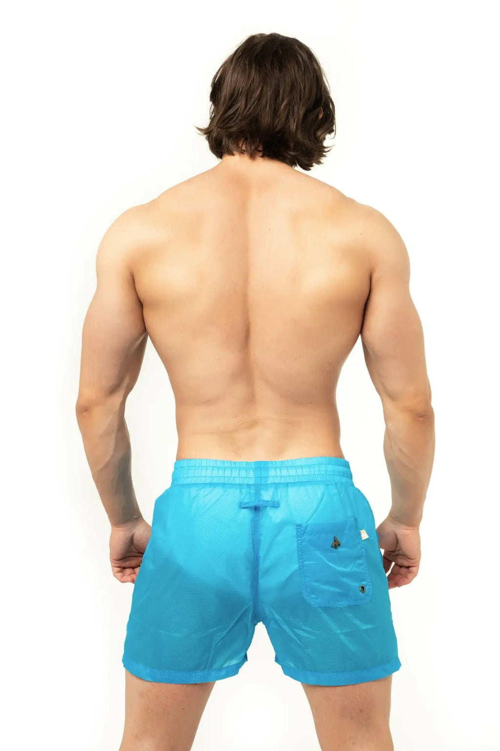 Marcuse Babylon shorts are bright blue lightweight swim trunks with subtle textured weave and black button accents on pocket