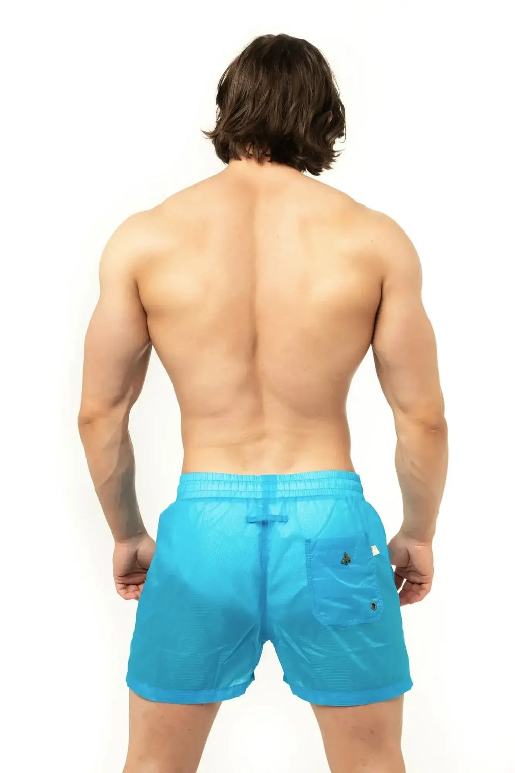 Marcuse Babylon shorts are bright blue lightweight swim trunks with subtle textured weave and black button accents on pocket