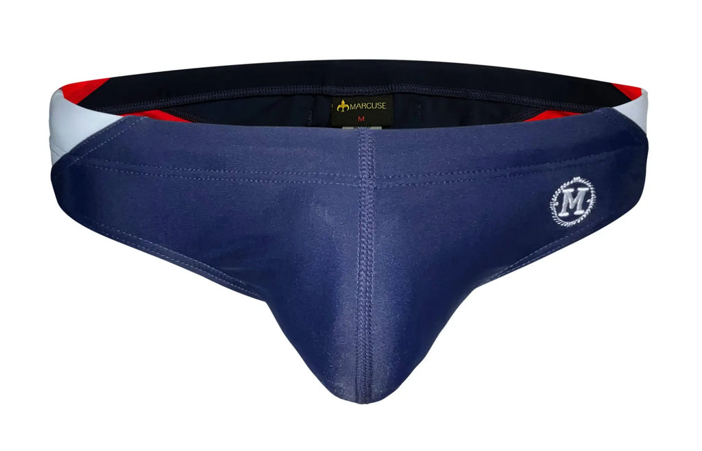 Navy blue men’s briefs with white and red trim featuring a circular m logo and marquee brand tag by Marcuse Bahama