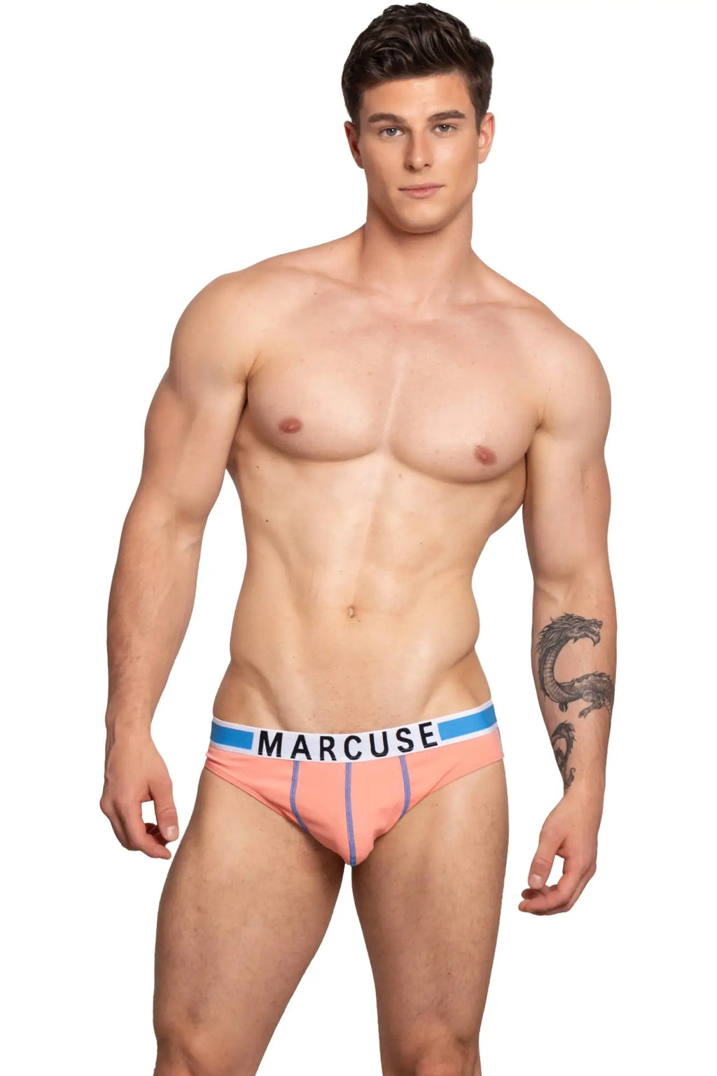 Peach-colored marcuse beckett brief underwear with blue and white branded waistband in bold black letters