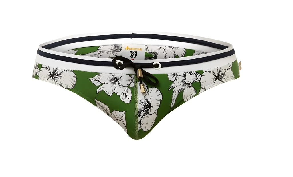 Green swim trunks by marcuse botany with white floral pattern and black trim for bikini swimwear use