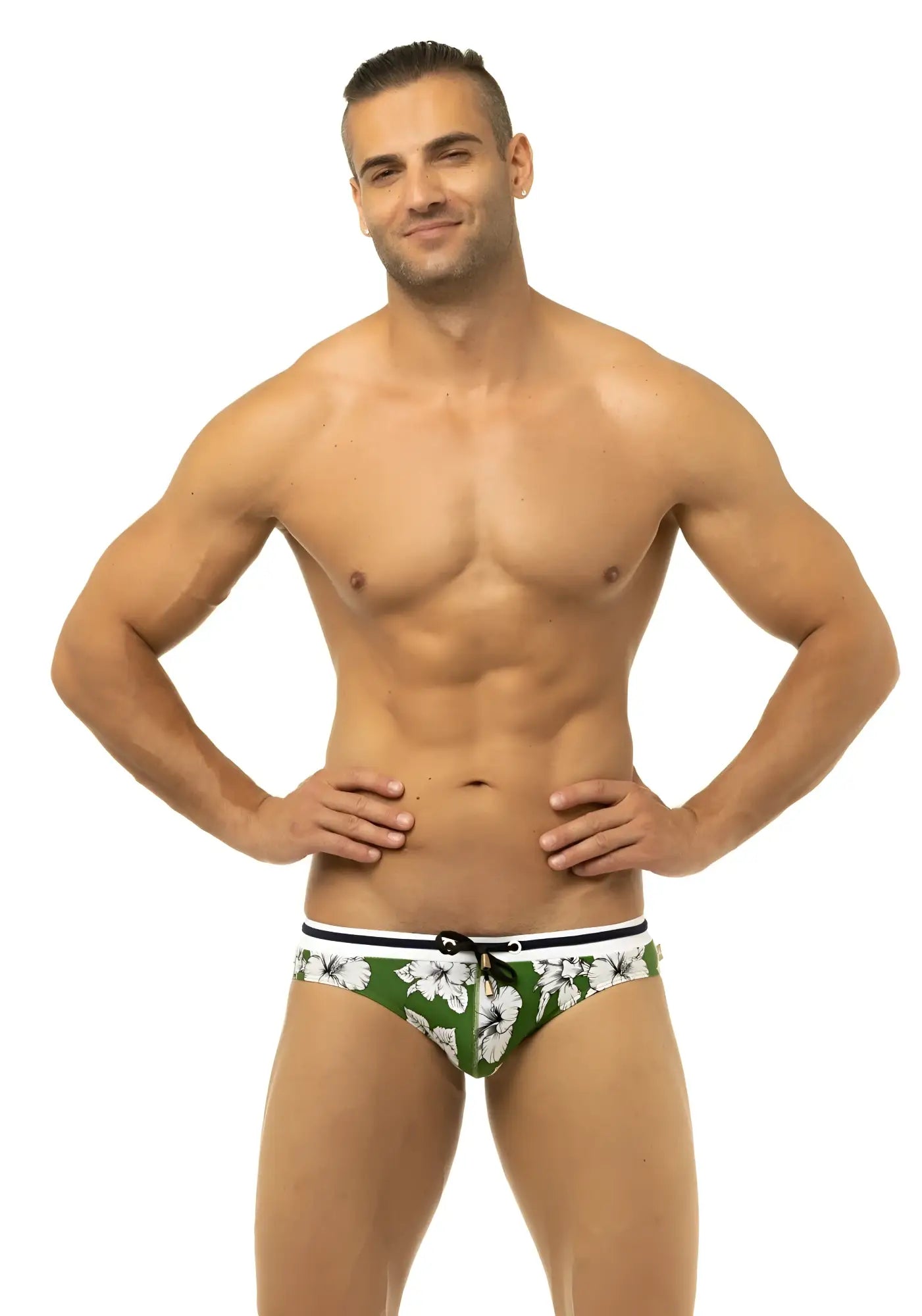 Green swim trunks with white hibiscus flower pattern and black trim from marcuse botany bikini swimwear