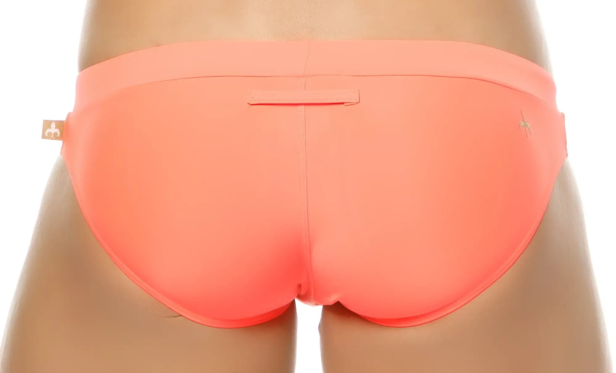 Coral-colored Marcuse Burleigh bikini swimwear swim trunks with smooth stretchy fabric and a small brand tag on the left hip
