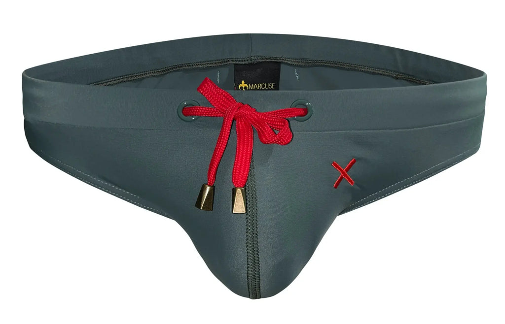 Dark gray marcuse burleigh bikini swimwear trunks with red drawstring bow gold aglets and embroidered red x on the side