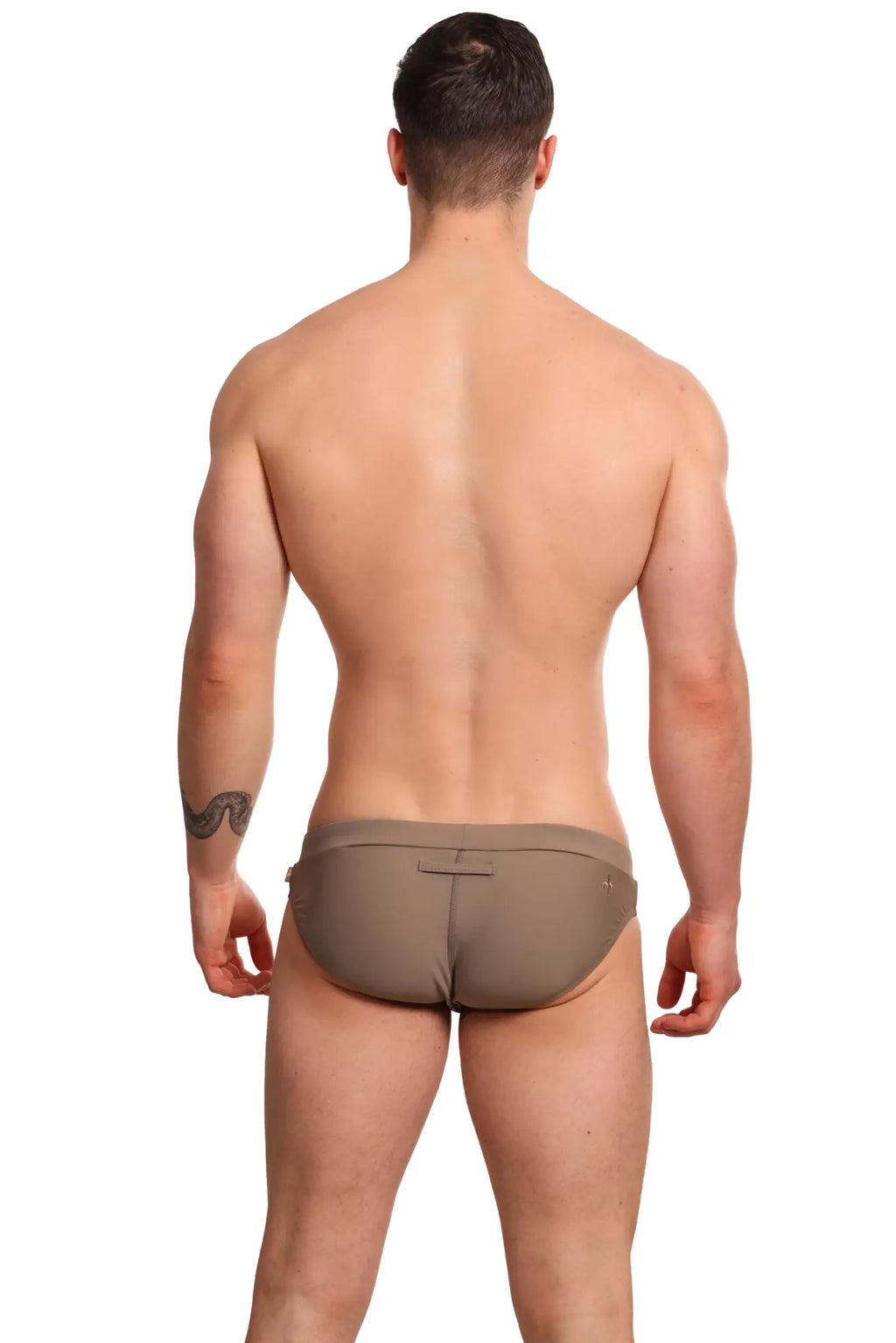Tan form-fitting marcuse burleigh bikini swim trunks with a subtle back closure detail for swimwear use