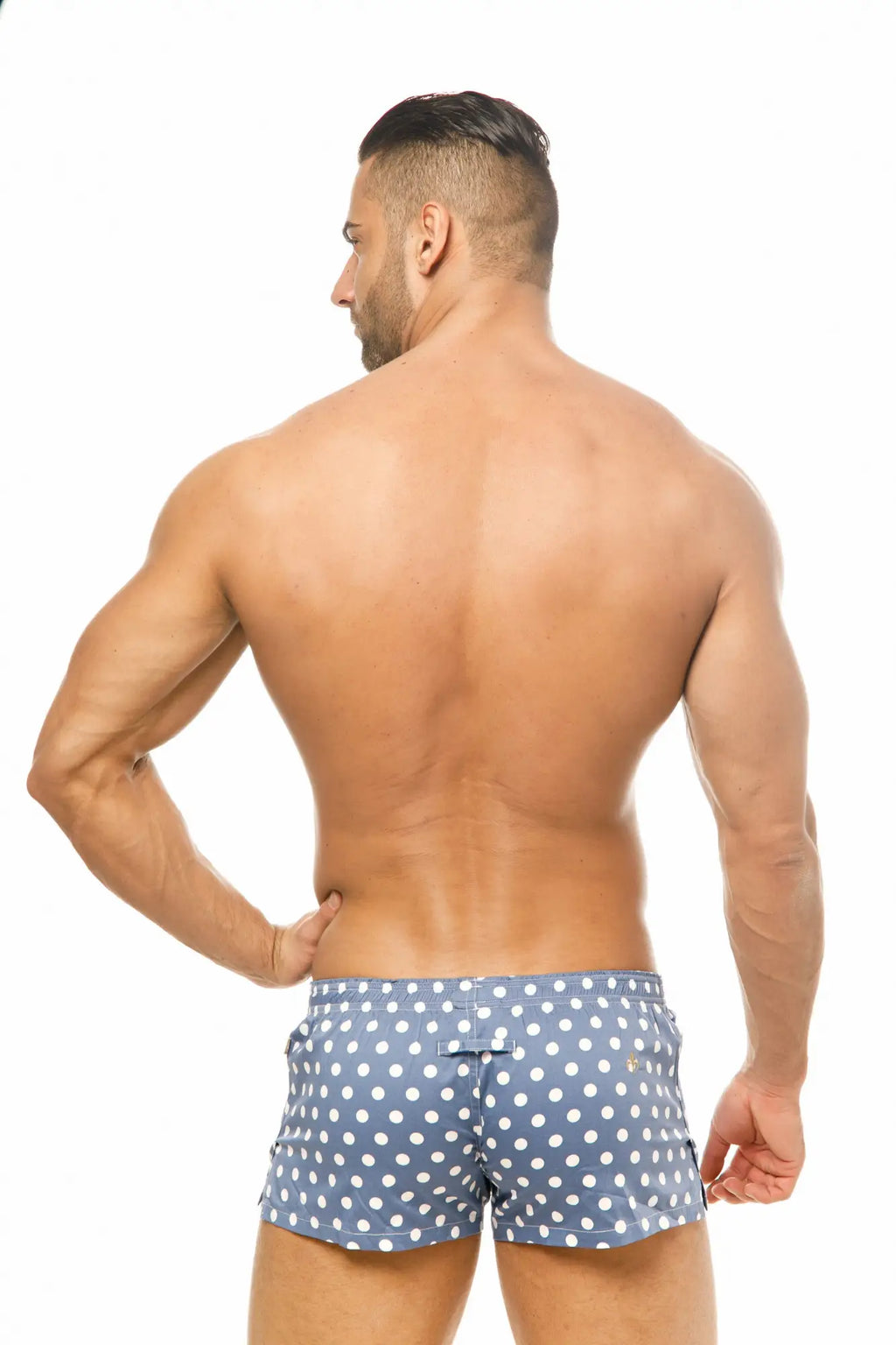 Back side of marcuse caleçon boxer underwear in blue polka-dot swim trunks with white dots and a small logo