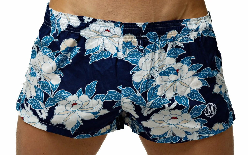 Navy blue Marcuse Caleçon boxer underwear with bold white and light blue floral pattern and circular logo on lower right leg
