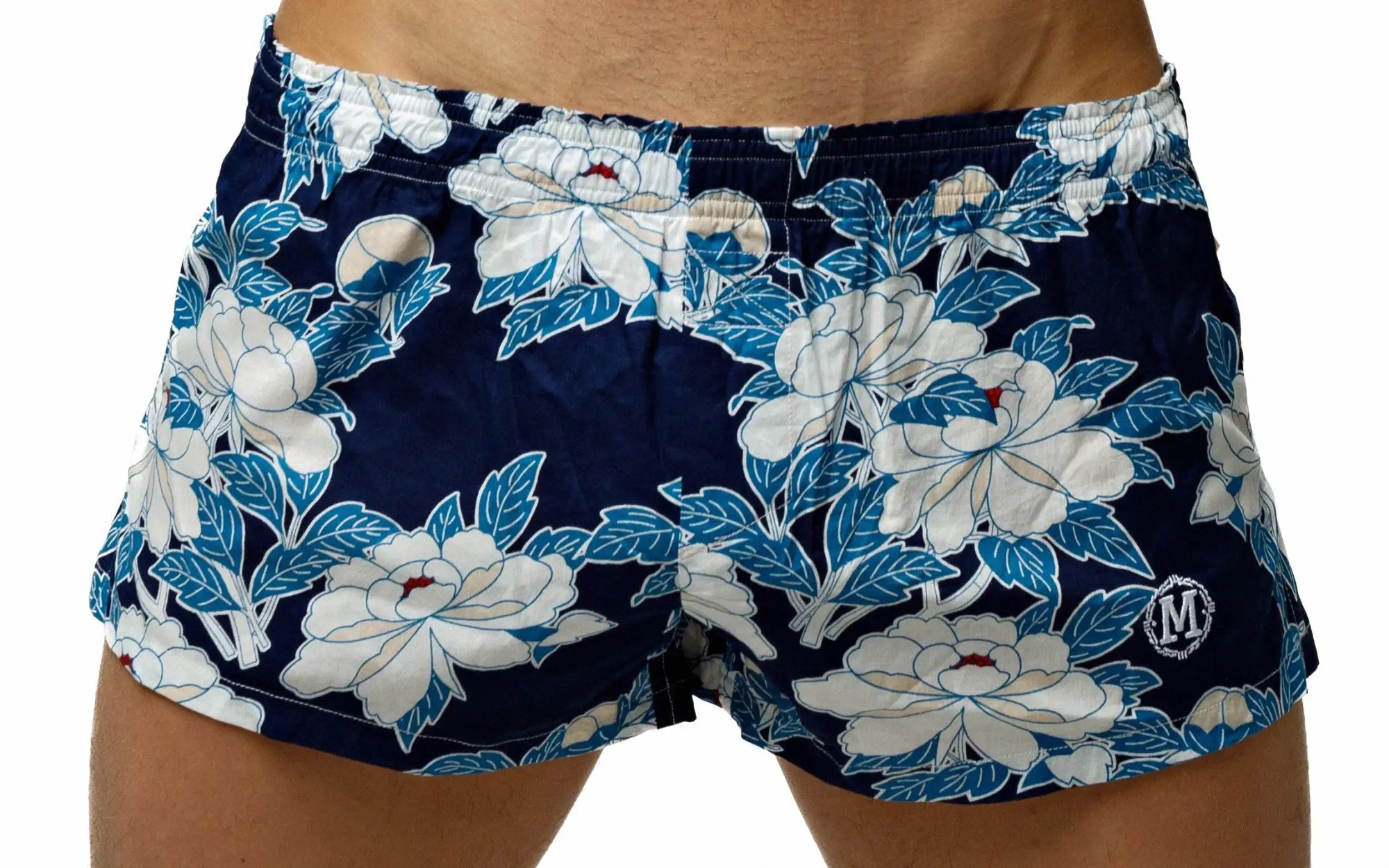 Navy blue Marcuse Caleçon boxer underwear with bold white and light blue floral pattern and circular logo on lower right leg