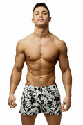 White swim trunks with black floral pattern from Marcuse Caleçon boxer underwear collection for beachwear use