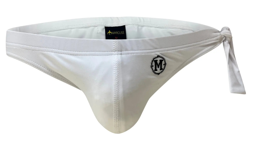 White Marcuse men’s thong with side tie and embroidered logo from Marcuse Caribbean bikini swimwear collection