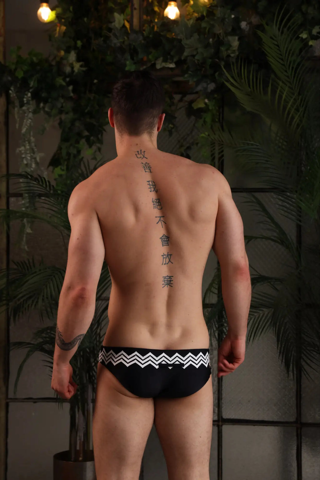 Black marcuse everest bikini swimwear trunks with bold white zigzag pattern on waistband for swimming beachwear