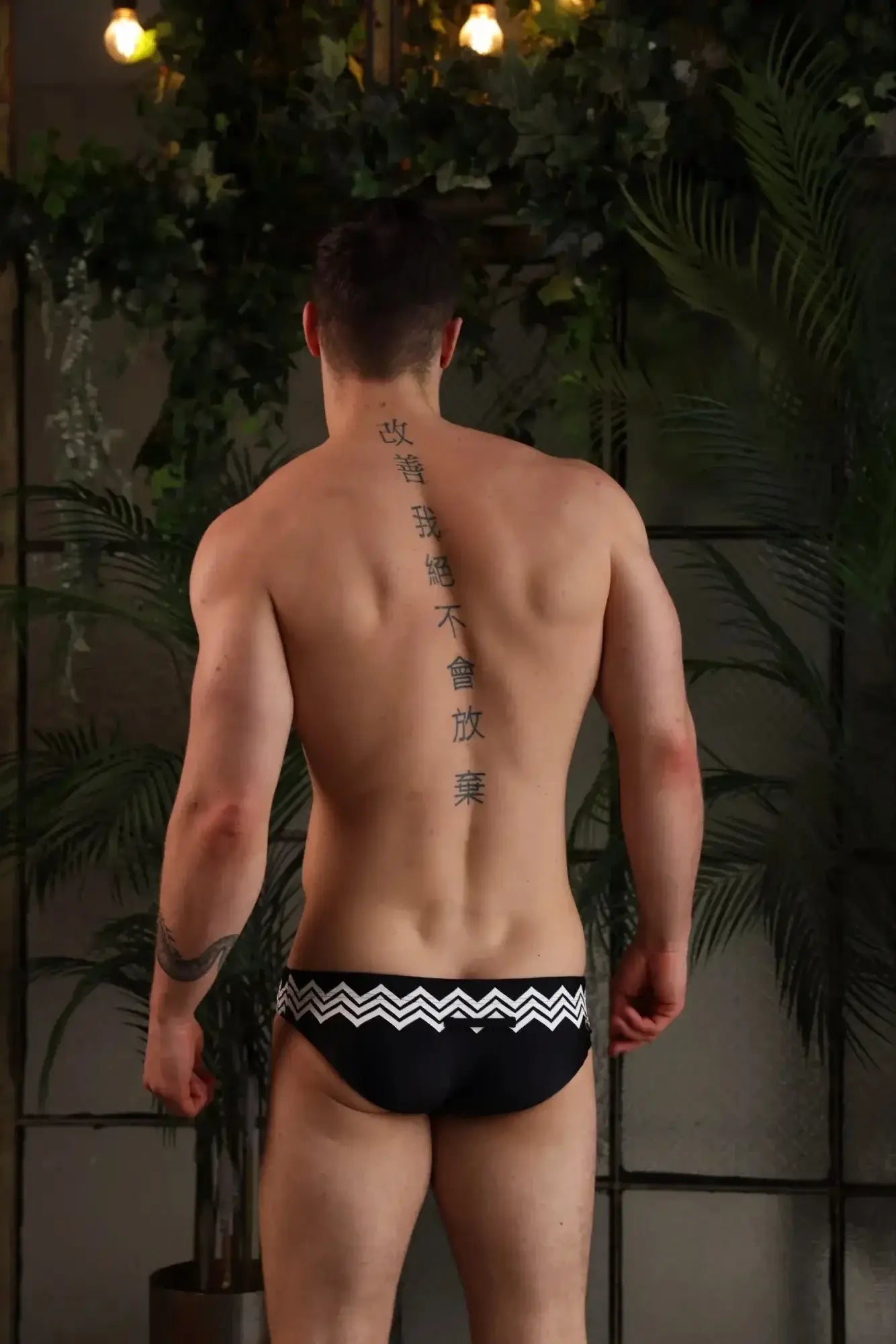 Black marcuse everest bikini swimwear trunks with bold white zigzag pattern on waistband for swimming beachwear