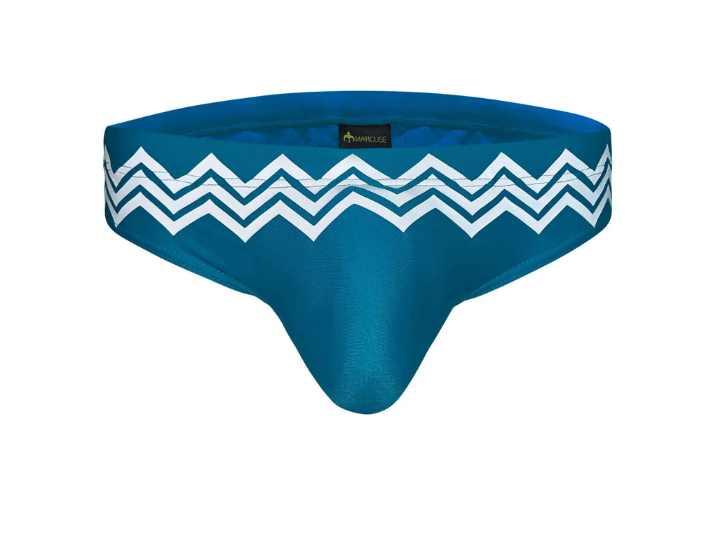 Marcuse Everest bikini swimwear teal blue men’s briefs with bold white zigzag pattern waistband front view