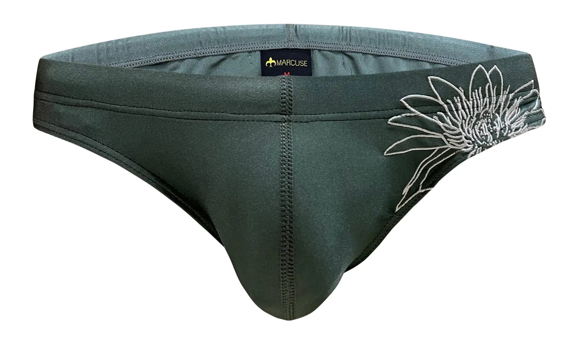 Dark green stretchy fabric briefs with white embroidered flower and marcuse black tag at waistband marcuse florets bikini swimwear