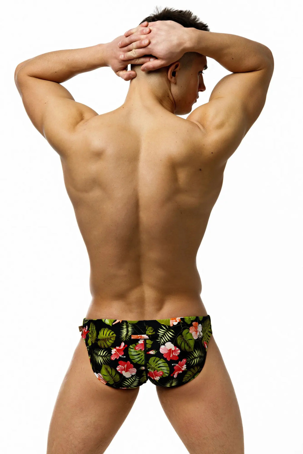 Marcuse Forrest brief swimwear black trunks with vibrant tropical pink hibiscus floral pattern and green leaves